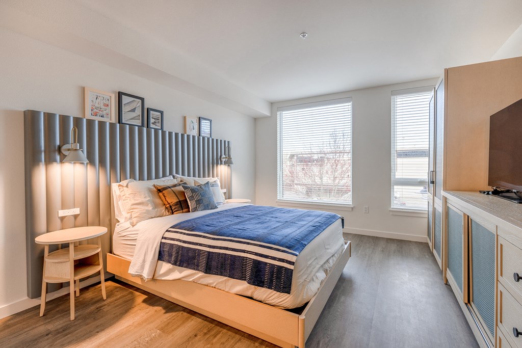 a bedroom with a bed and a desk with a chair at Marina Square, WA 98337