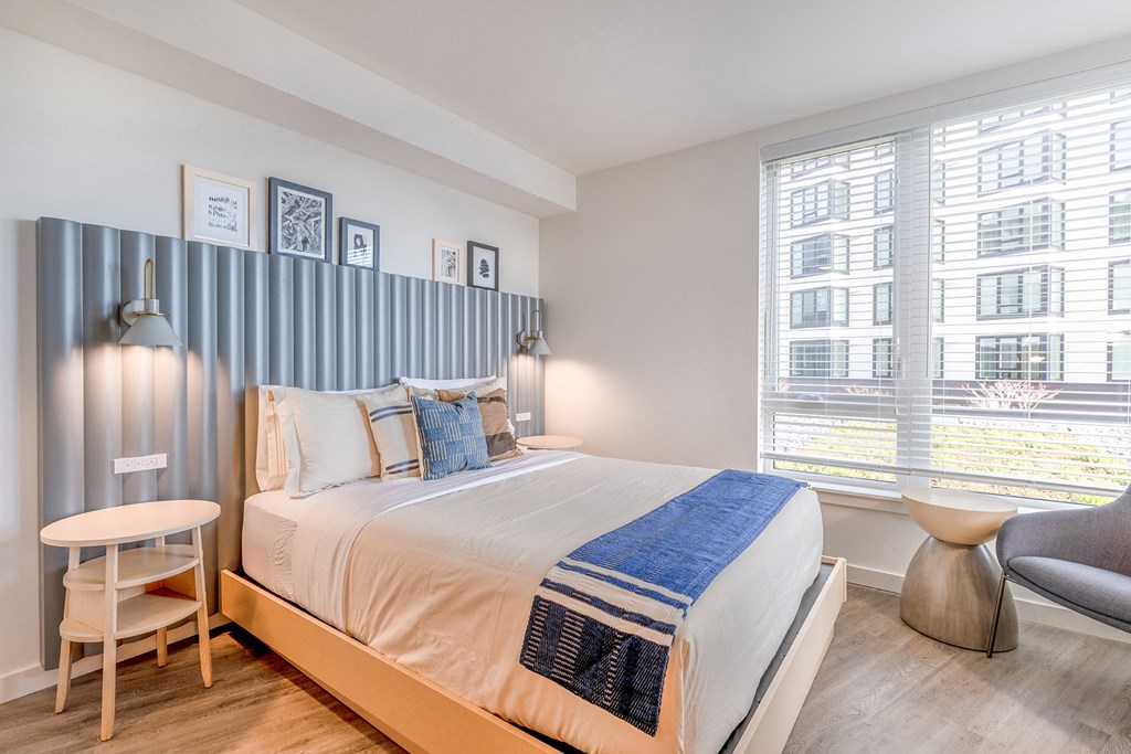 a bedroom with a bed and two windows at Marina Square, Bremerton, Washington 98337