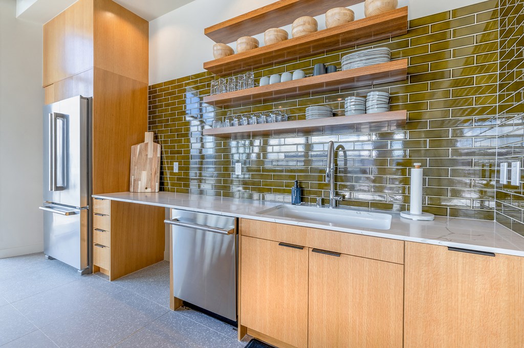a kitchen with wood cabinets and stainless steel appliances at Marina Square, Bremerton, 98337
