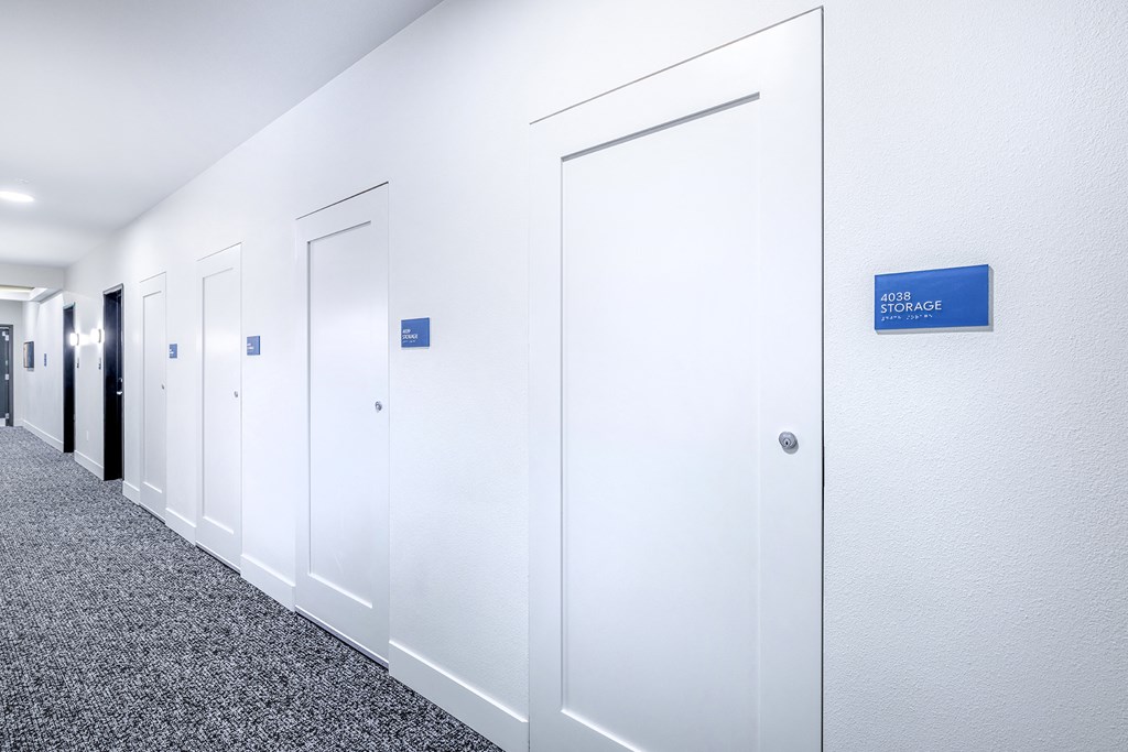 a row of white offices with a blue sign on the wall at Marina Square, WA 98337