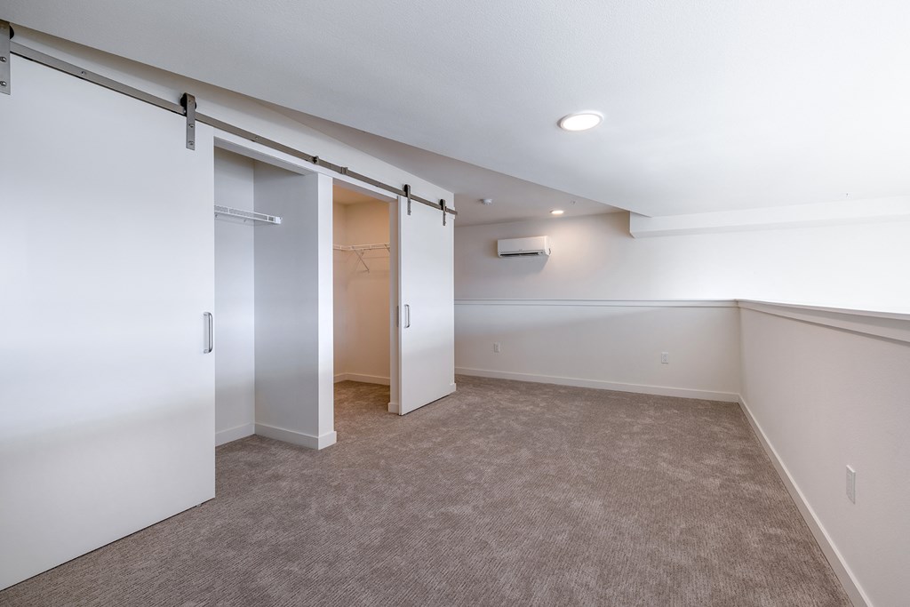 a bedroom with a closet and a carpeted floor at Marina Square, Washington, 98337