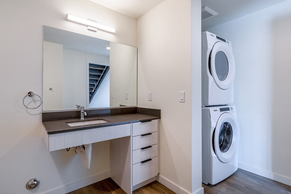 a bathroom with a sink and a washer and dryer at Marina Square, Washington