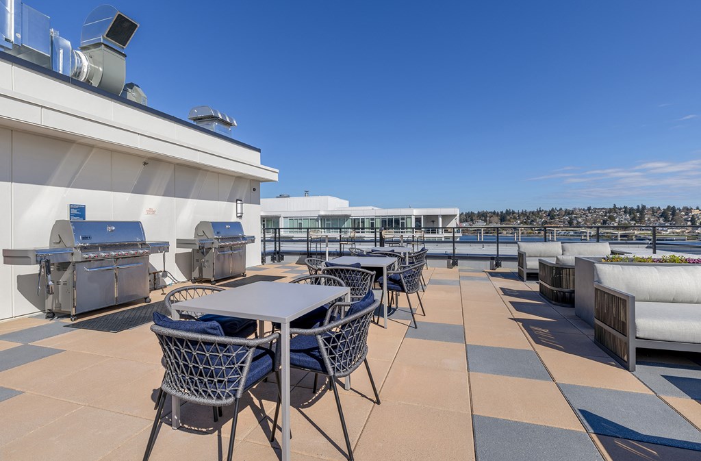 a terrace with tables and chairs on the top of a building at Marina Square, Bremerton, 98337