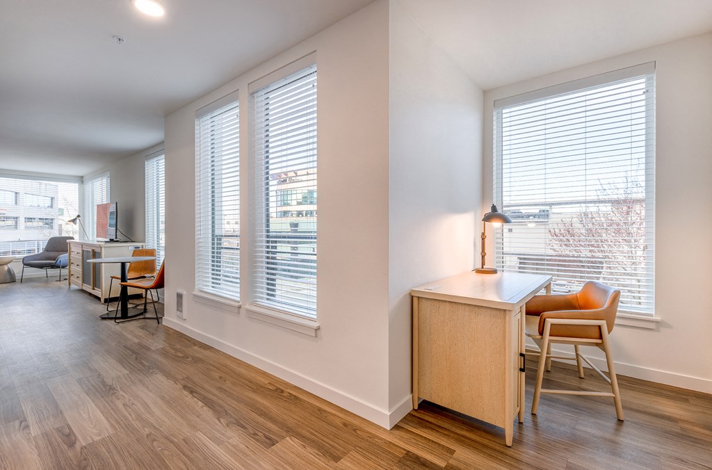 a living area with hardwood floors and large windows at Marina Square, WA 98337