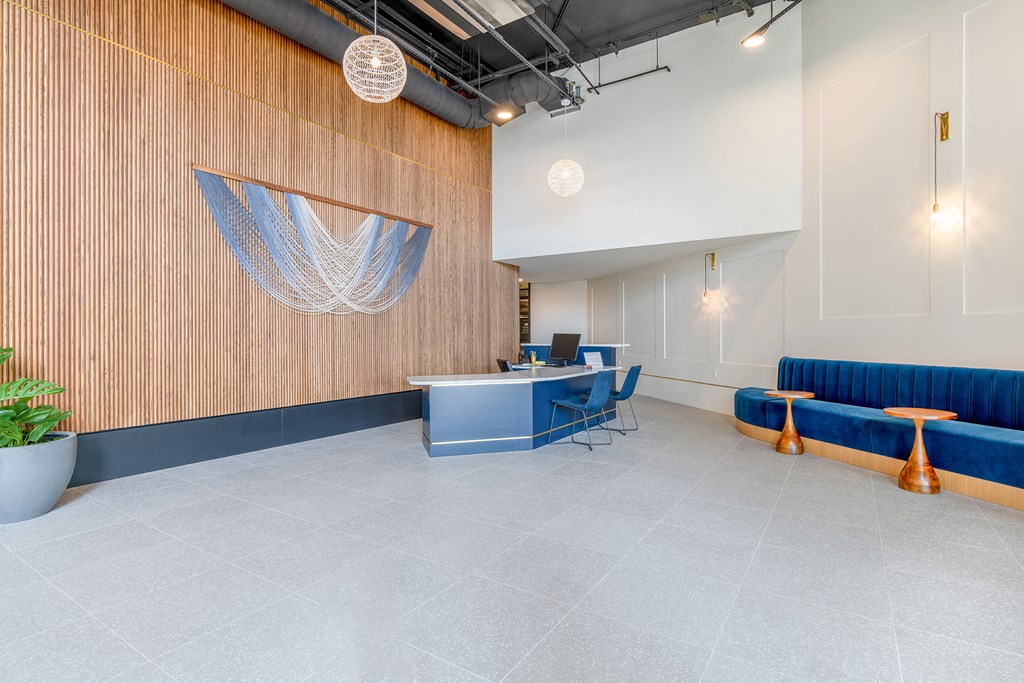 a room with blue couches and chairs and a table with a computer on it at Marina Square, Bremerton, 98337