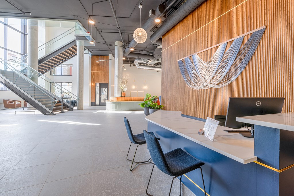 a large open space with a blue desk and blue chairs at Marina Square, WA 98337