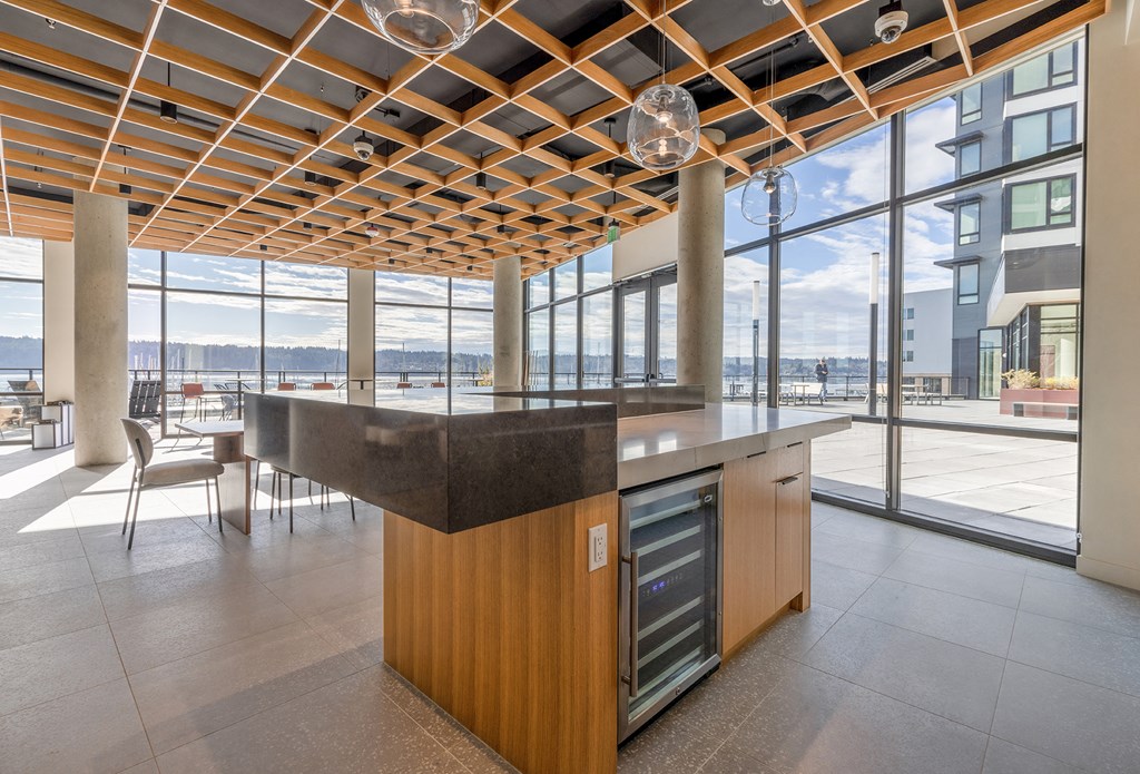 a kitchen with a large island in the middle of a room with floor to ceiling windows at Marina Square, Bremerton, Washington 98337