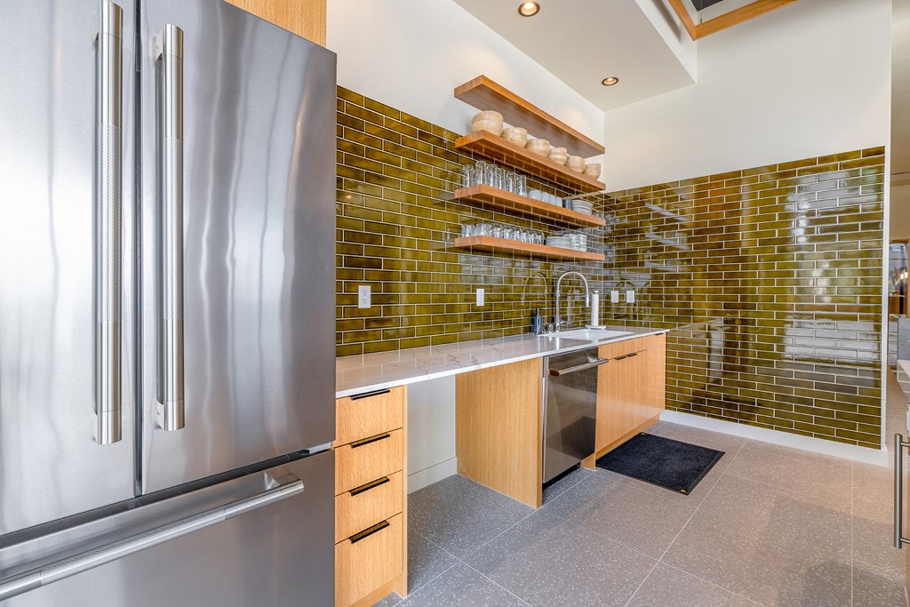 a kitchen with green tile and stainless steel appliances at Marina Square, Bremerton, WA