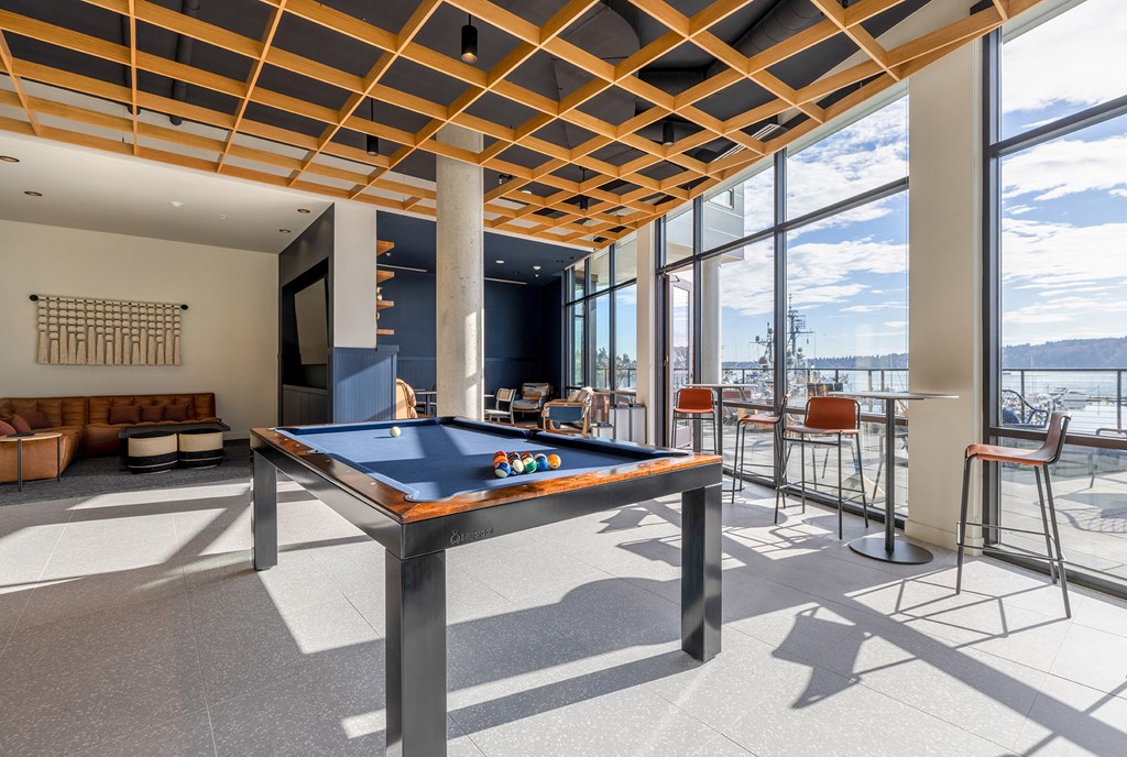 Game Lounge with a pool table, lounging couches, and floor to ceiling windows at Marina Square, WA 98337