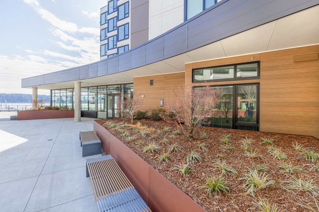 a courtyard with benches and plants next to a building at Marina Square, WA 98337