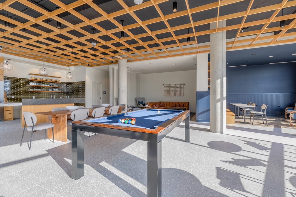 a games room with a pool table and a bar in the background at Marina Square, Bremerton