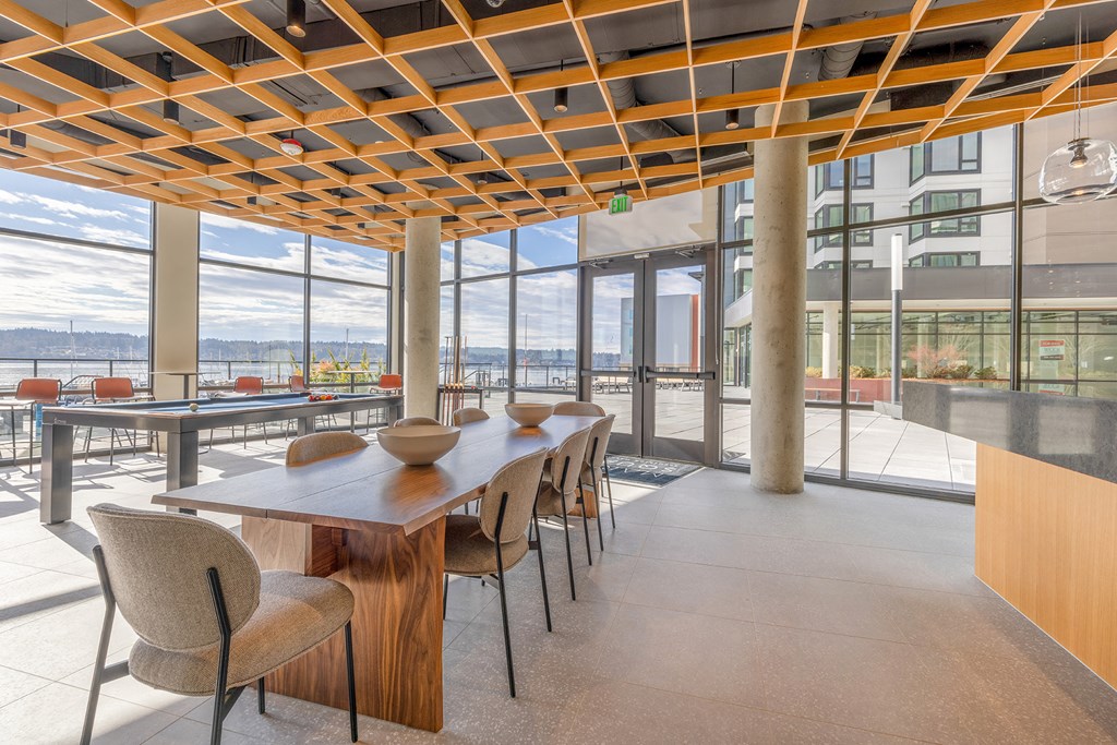 a dining area with a long wooden table and chairs at Marina Square, Washington, 98337