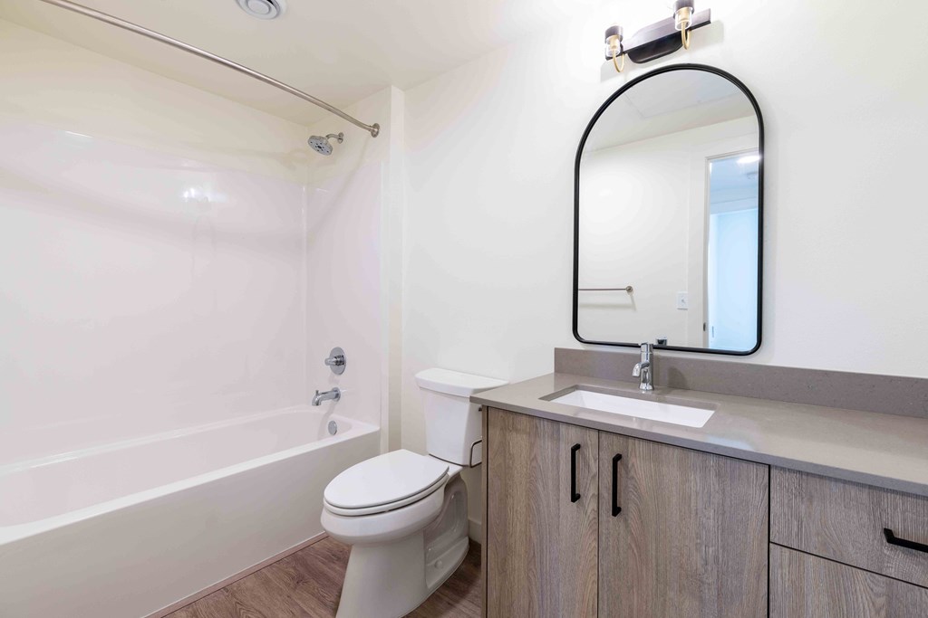 a bathroom with a toilet sink and a mirror at Rivulet, Silverdale, WA