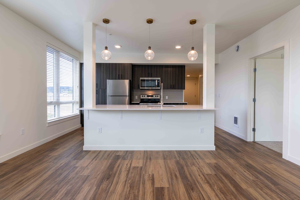 a kitchen and living room with a white counter top and at Rivulet, Silverdale, WA