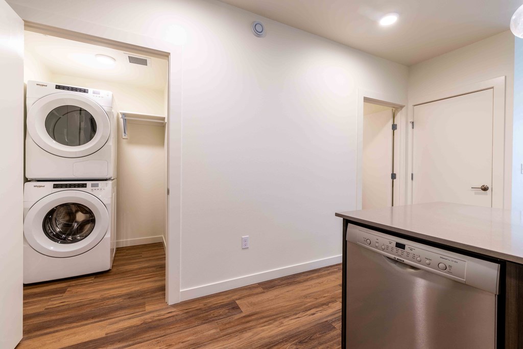 a washer and dryer in a laundry room with a counter top and at Rivulet, Silverdale Washington