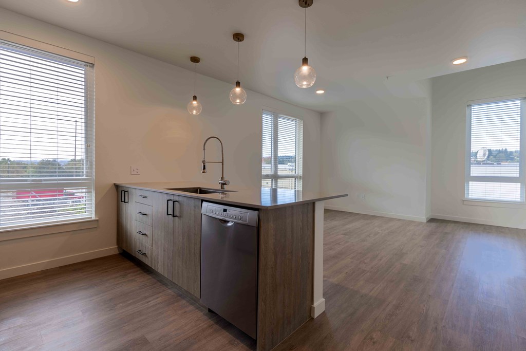 an empty kitchen with a large island in the middle at Rivulet, Silverdale Washington