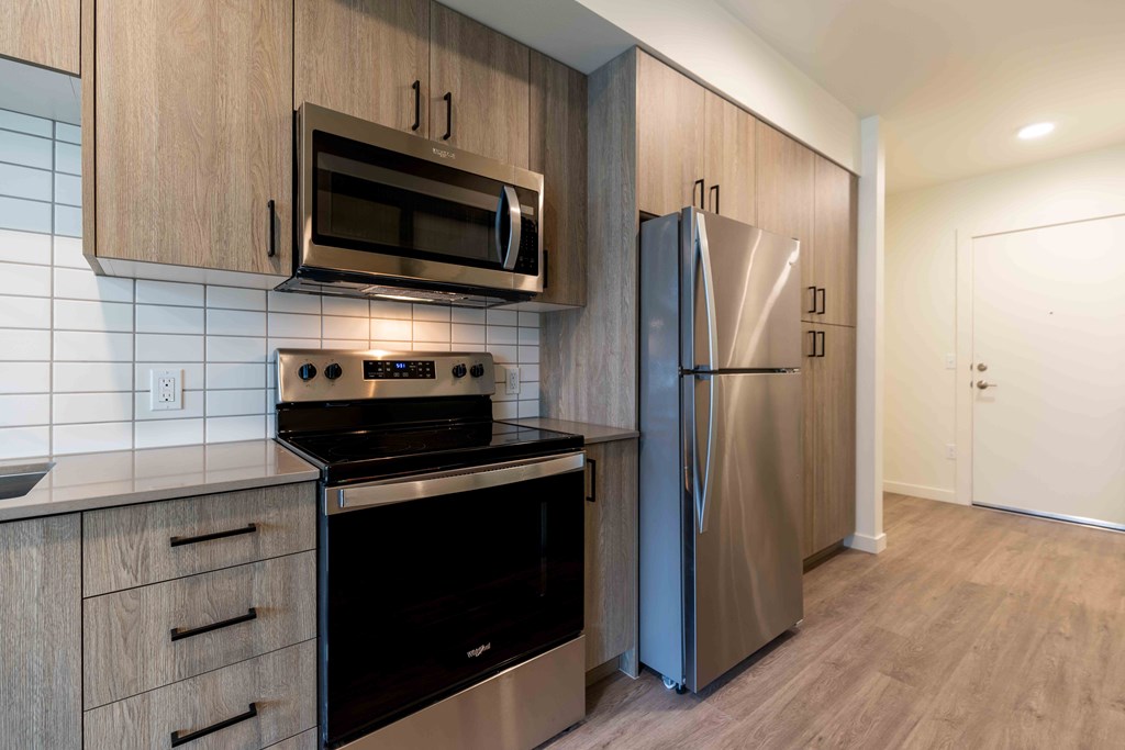 a kitchen with stainless steel appliances and a refrigerator at Rivulet, Washington, 98383