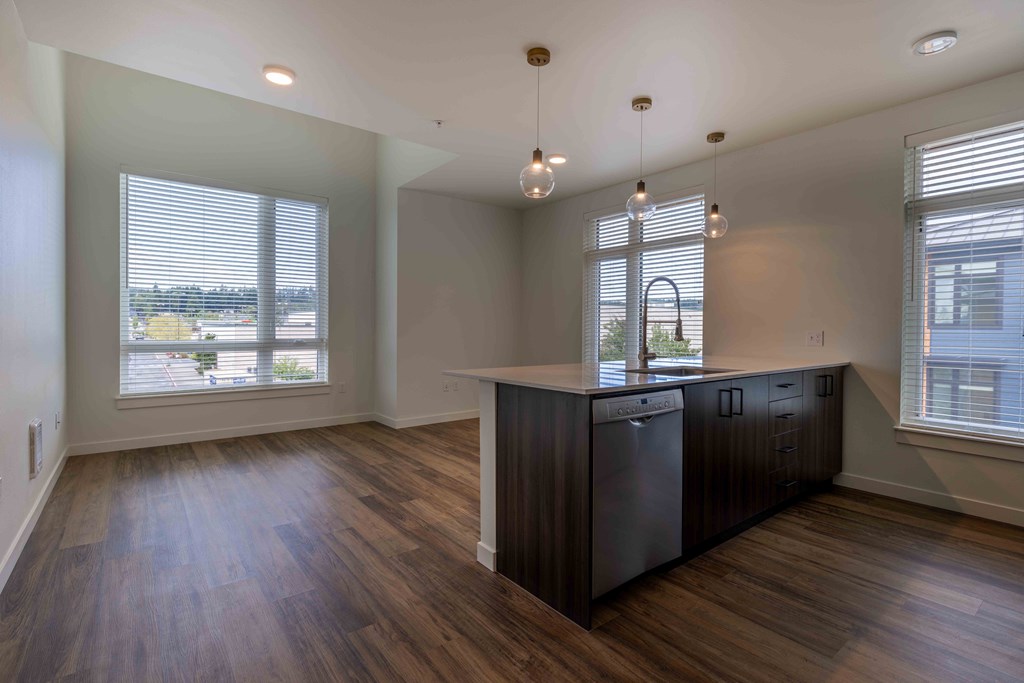 an empty kitchen with a large window and a counter top at Rivulet, Silverdale