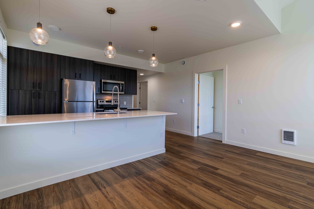 a kitchen with a large island and a stainless steel refrigerator at Rivulet, Silverdale, WA