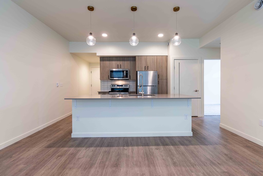 a large kitchen with a counter top and a refrigerator at Rivulet, Silverdale, 98383