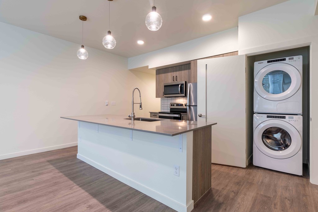 a washer and dryer in a kitchen with a counter and a washing machine at Rivulet, Silverdale