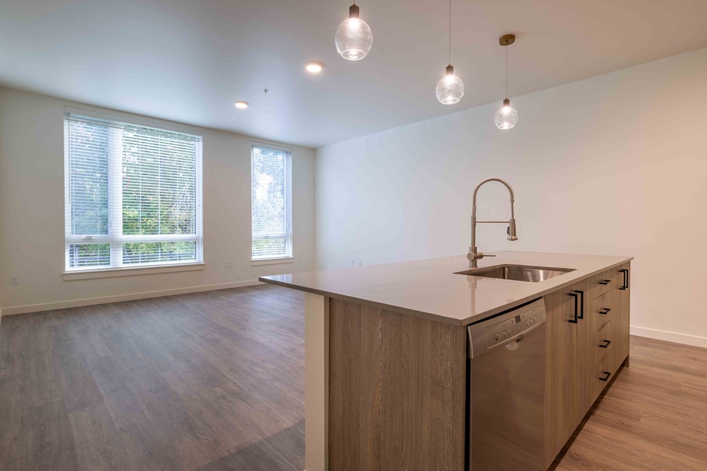 an empty kitchen with an island in the middle at Rivulet, Silverdale, 98383