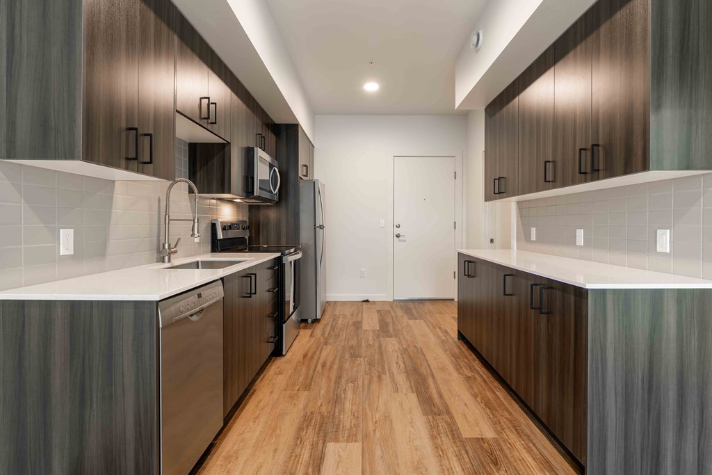 a renovated kitchen with wooden floors and stainless steel appliances at Rivulet, Silverdale