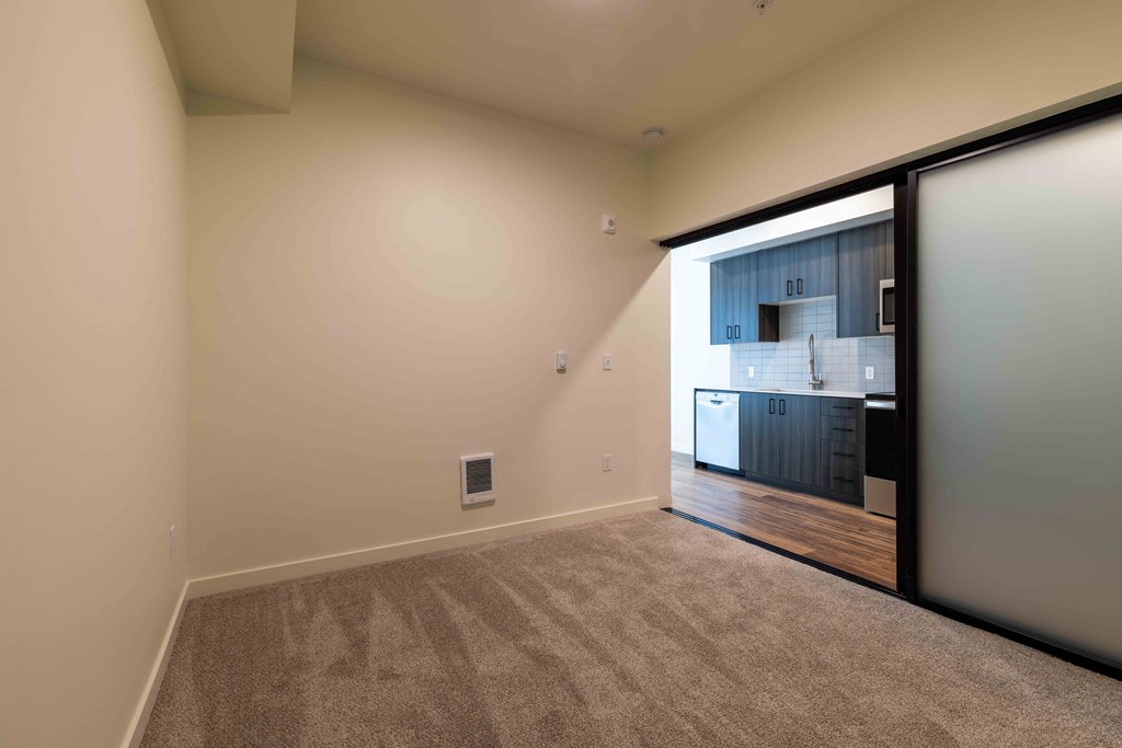 a room with a door to the kitchen and carpeted flooring at Rivulet, Washington