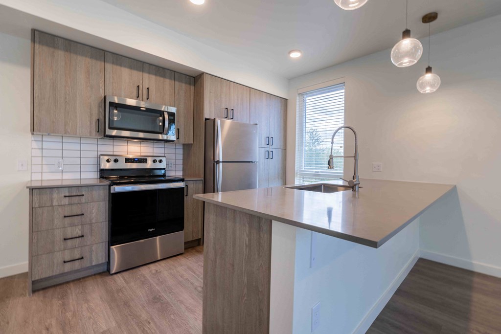 a kitchen with stainless steel appliances and a counter top at Rivulet, Silverdale, 98383