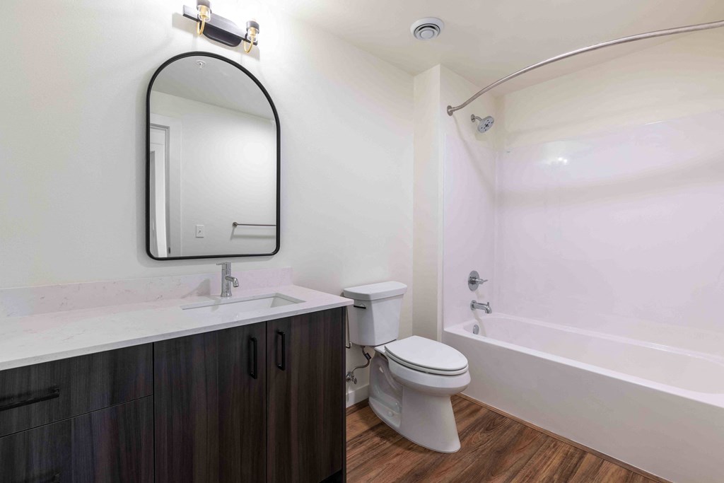 a bathroom with a toilet sink and a mirror at Rivulet, Silverdale Washington