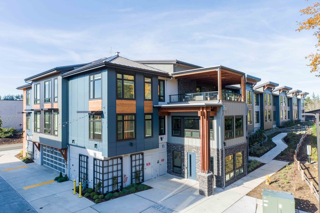 a building with many windows and a sidewalk at Rivulet, Silverdale, 98383