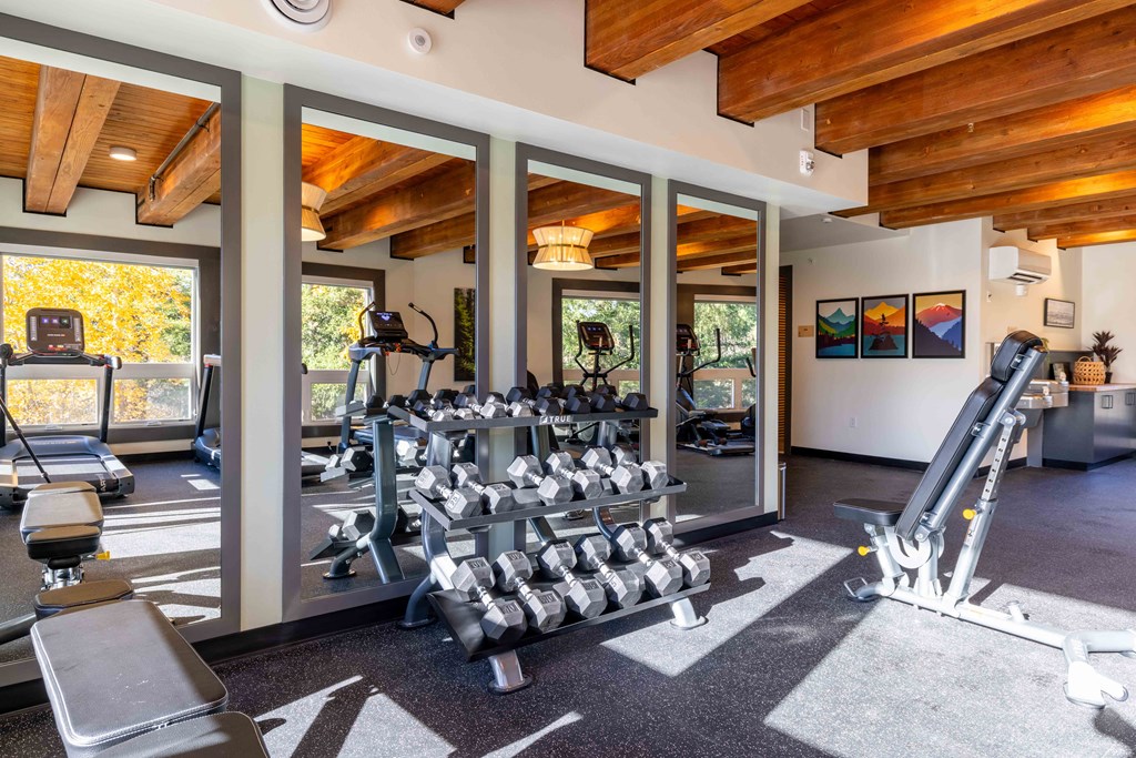 the gym is stocked with weights and cardio equipment at Rivulet, Silverdale, 98383