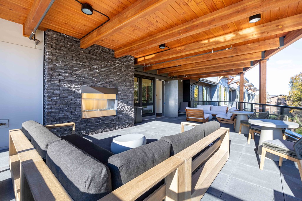 a patio with couches and tables and a fireplace at Rivulet, Silverdale, 98383