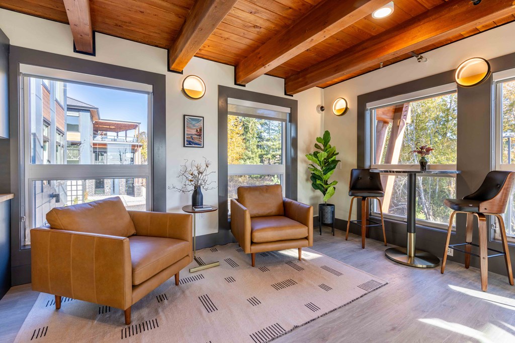 a living room with two chairs and a bar with windows at Rivulet, Washington