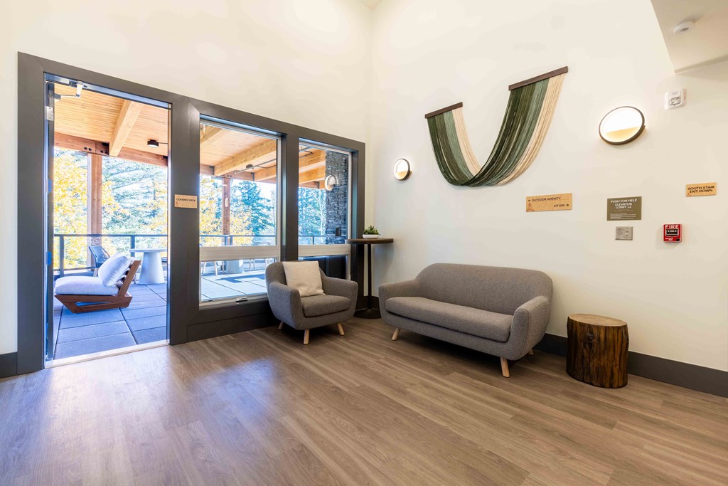 a living room with couches and chairs and a door to a balcony at Rivulet, Silverdale Washington