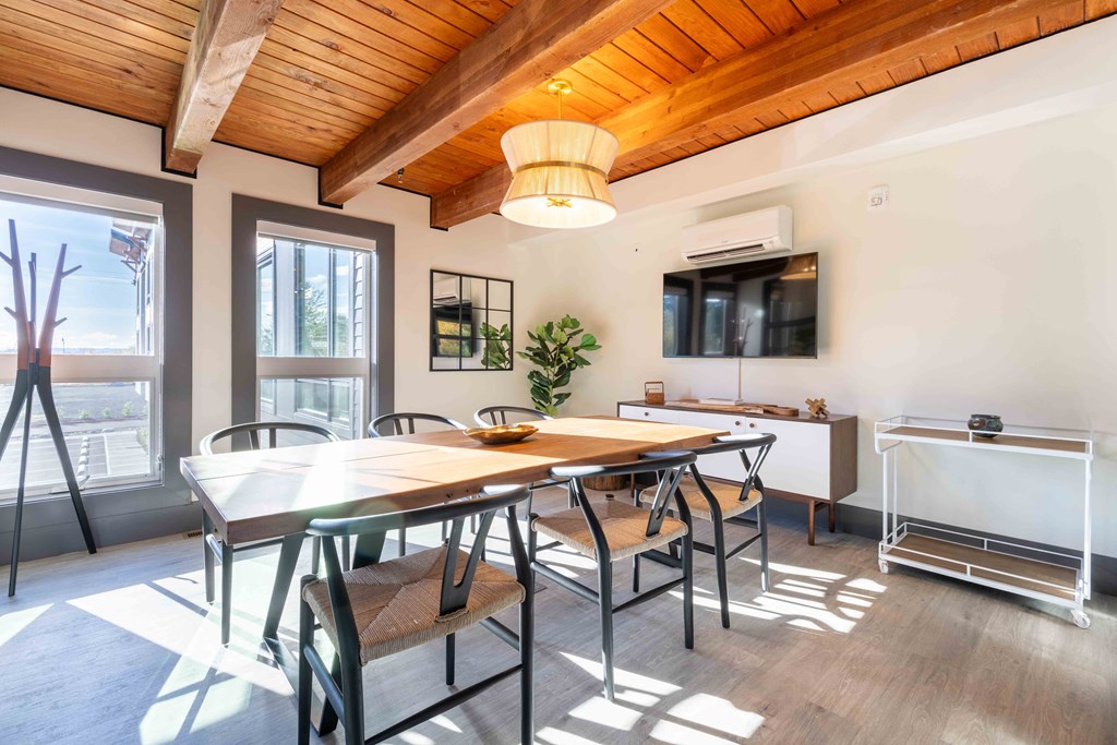 a dining room with a table and chairs      and a kitchen at Rivulet, Washington