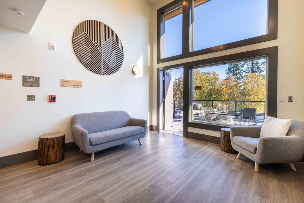 a living room with two couches and a large window at Rivulet, Washington