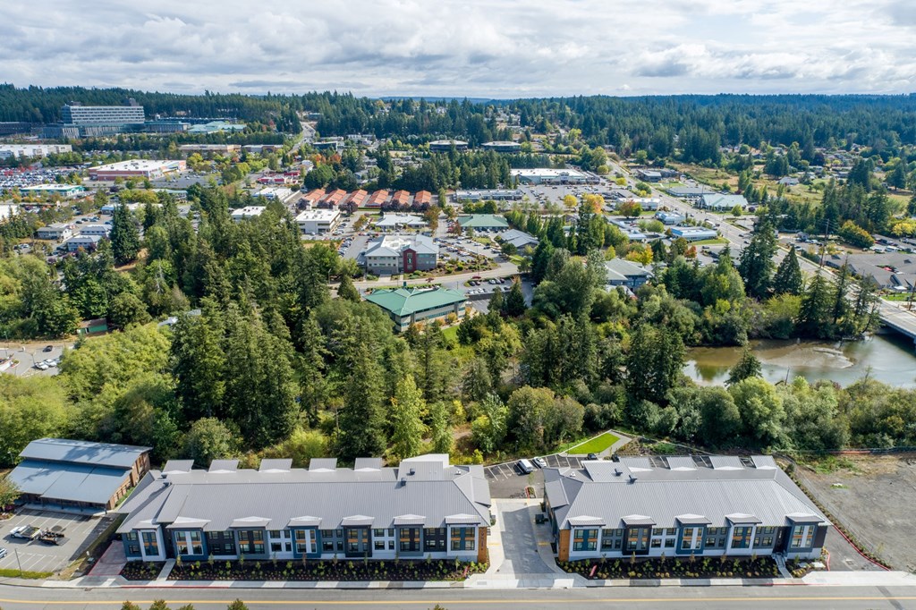 an aerial view of a city with trees and buildings at Rivulet, Silverdale, WA