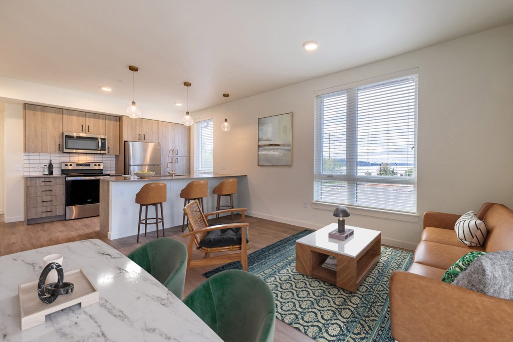 an open living room and kitchen with a table and chairs at Rivulet, Silverdale, WA