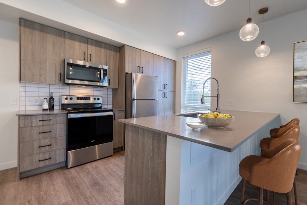 a kitchen with stainless steel appliances and a counter top at Rivulet, Washington, 98383