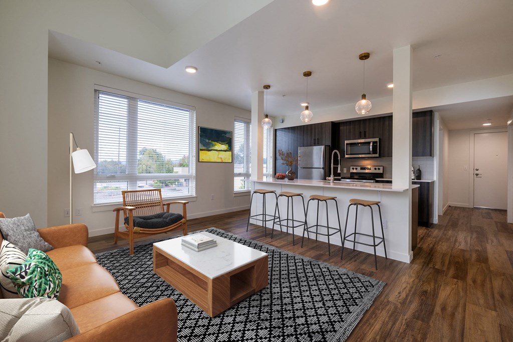 a living room with a kitchen with a bar and a couch at Rivulet, Silverdale, WA