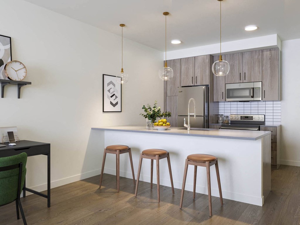 a kitchen with a large center island next to a stove top oven at Rivulet, Washington