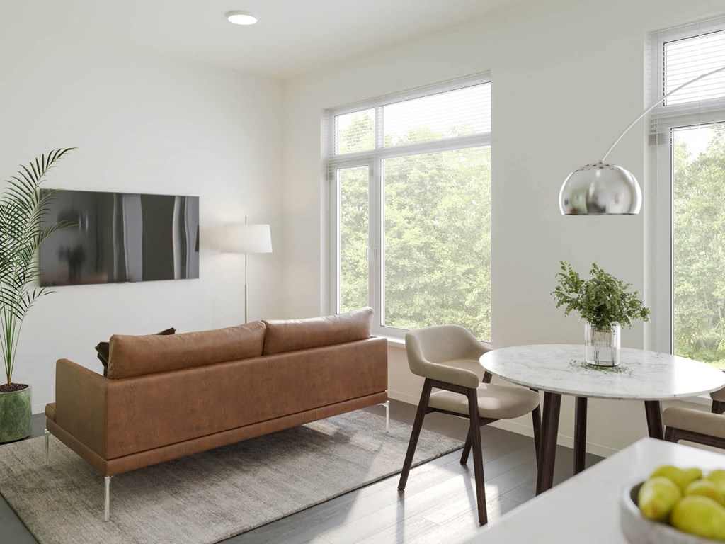 a living room with white walls and a brown couch at Rivulet, Silverdale, 98383