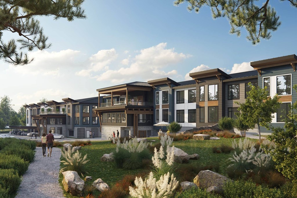 a rendering of a development of townhomes with a grassy area and rocks in the