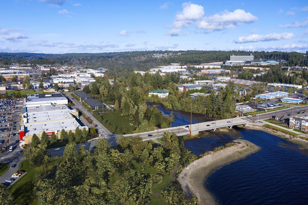 an aerial view of a city with a bridge over a body of water