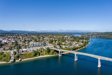 a bridge over a body of water with a city in the background and a river at Spyglass Hill Apartments, Washington