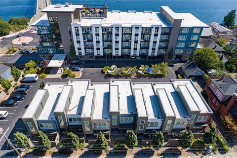 an aerial view of an apartment complex with a body of water in the background at Spyglass Hill Apartments, Bremerton, Washington