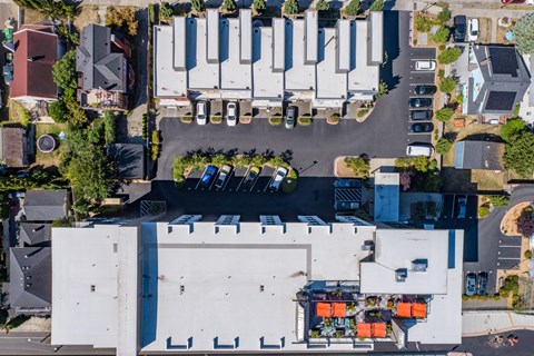 an aerial view of a parking lot with cars parked on top of a building at Spyglass Hill Apartments, Bremerton