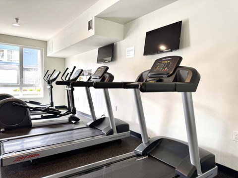 A treadmill with a LG brand logo is in a gym  at Spyglass Hill Apartments, Bremerton, 98337