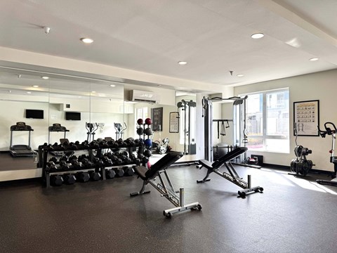 A gym with a variety of equipment including weights and cardio machines  at Spyglass Hill Apartments, Bremerton, 98337